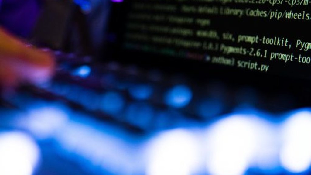 Backdoor logicielle – écran de terminal avec code sur laptop dans ambiance sombre