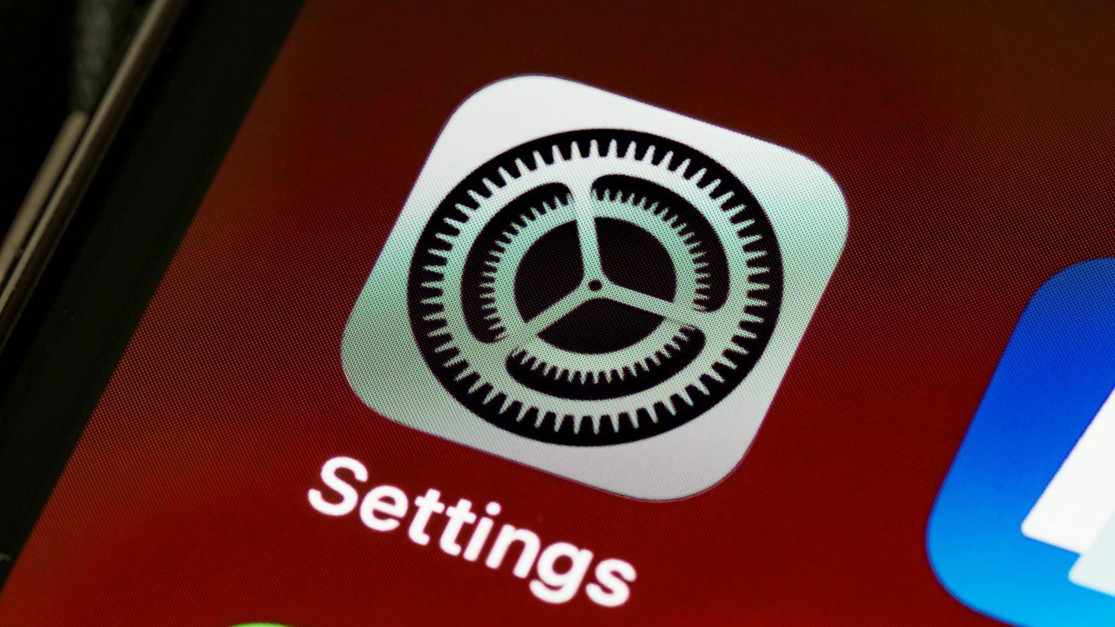 Detailed view of the iPhone screen showing the settings app icon.