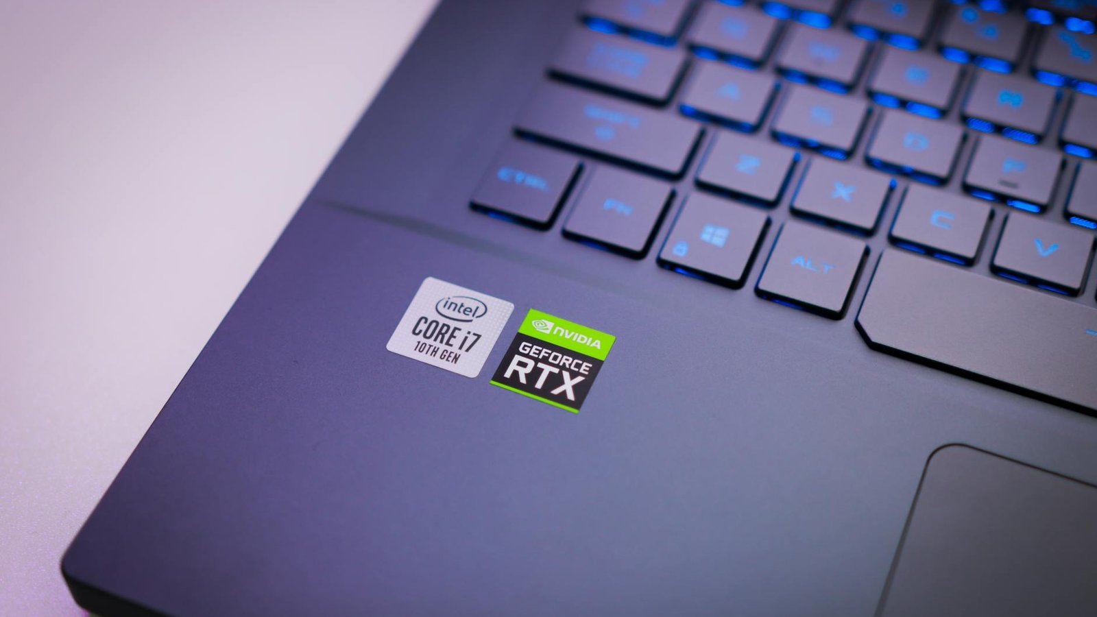 Laptop keyboard with Intel Core i7 and NVIDIA GeForce RTX stickers, symbolizing high-performance computing power.