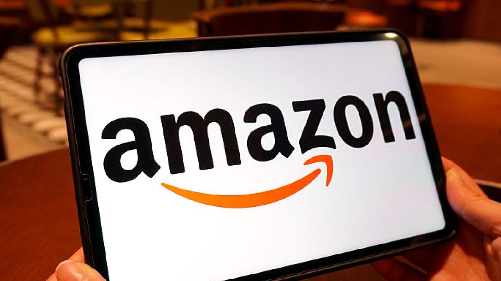 Livraison Amazon – logo sur tablette posée sur table de café
